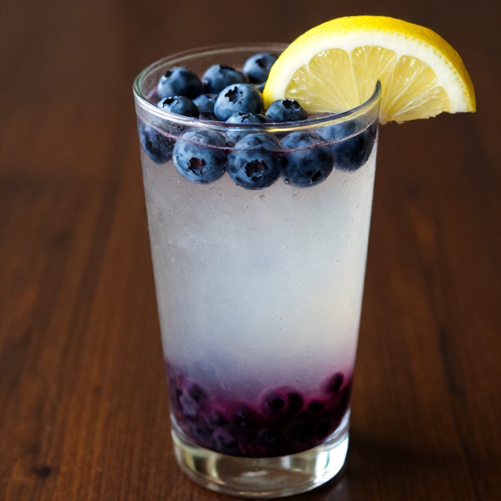Blueberry coconut water drink garnished with a lemon slice