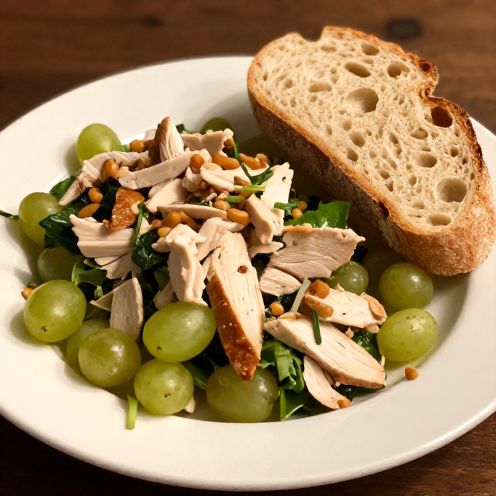 Plated Chicken Grape Salad with a side of crusty bread