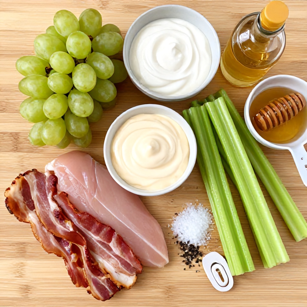 Raw ingredients for Chicken Grape Salad on a wooden surface