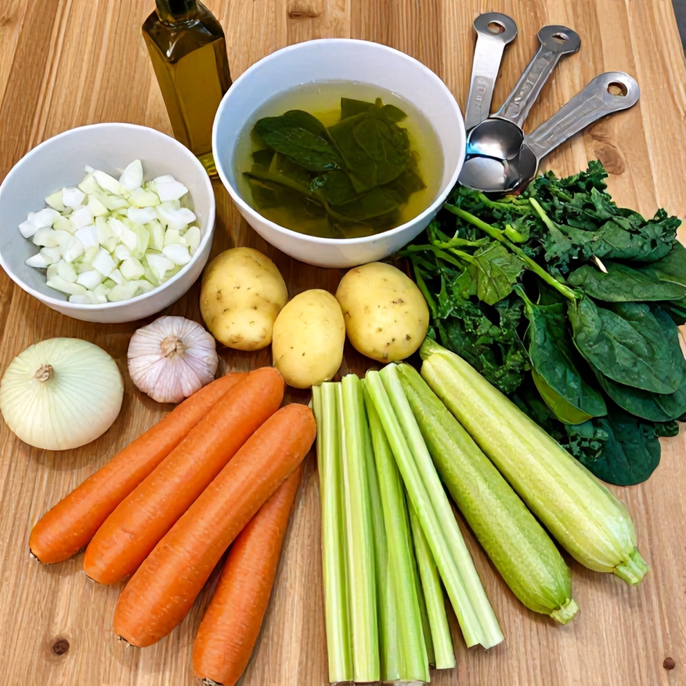 Green vegetables and ingredients for soup on a wooden table