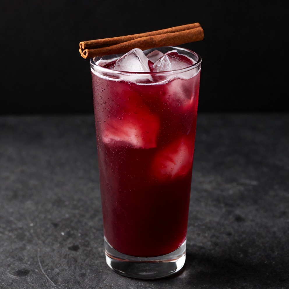 Hibiscus Cardamom Iced Latte poured over ice in a glass
